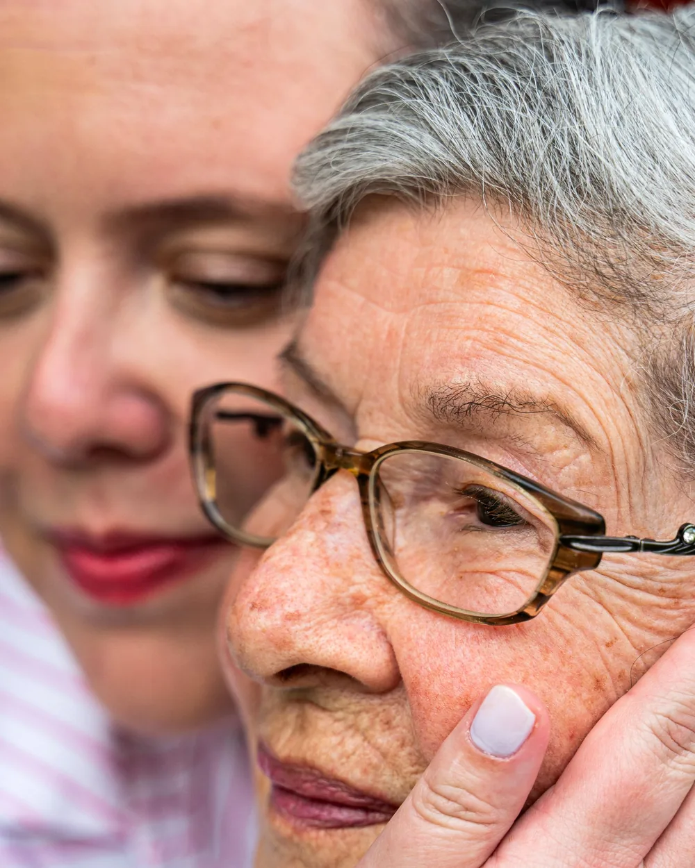 An older woman sharing a reassuring moment with another person