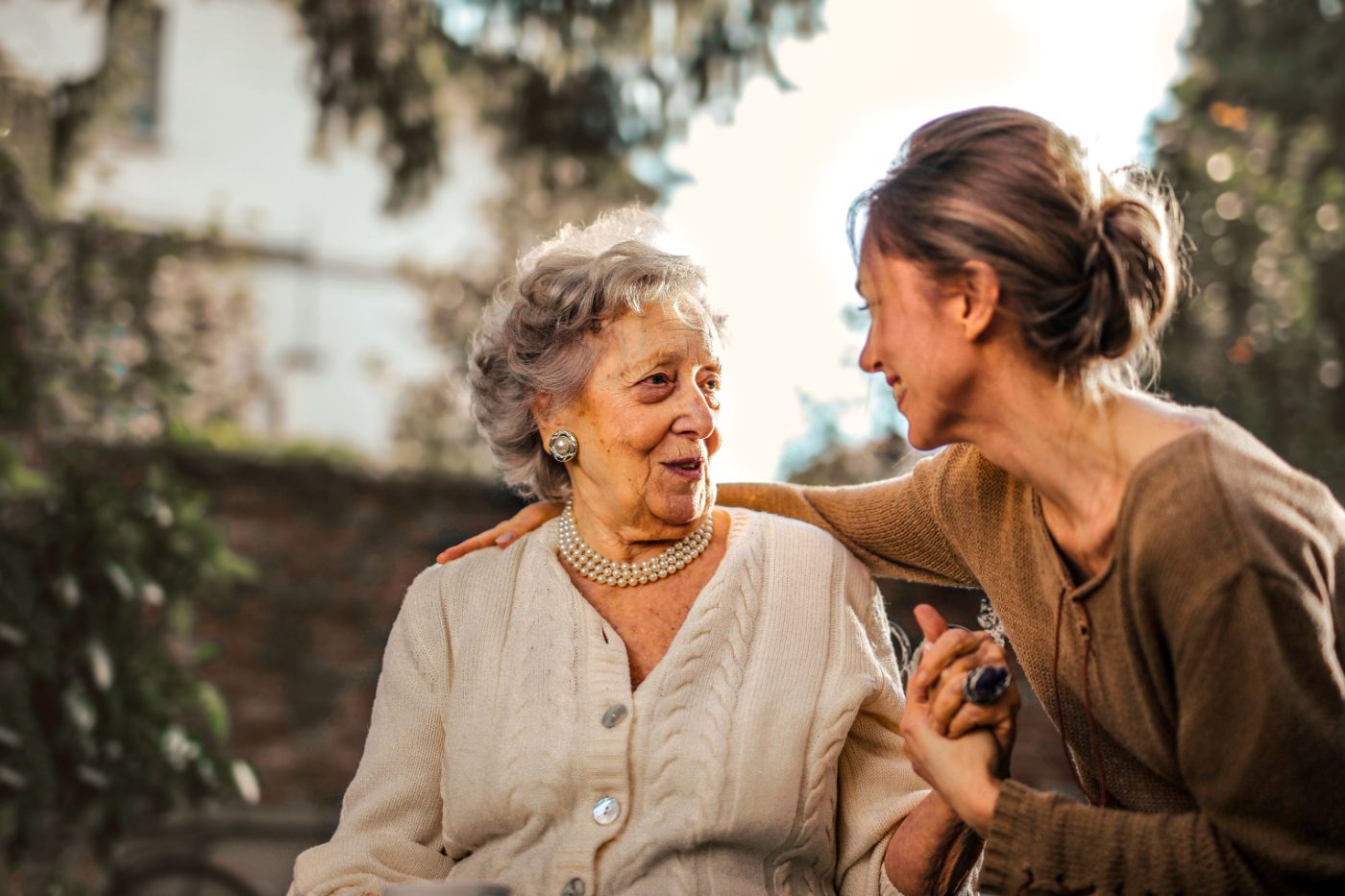 Carer and resident sharing a warm moment together outdoors