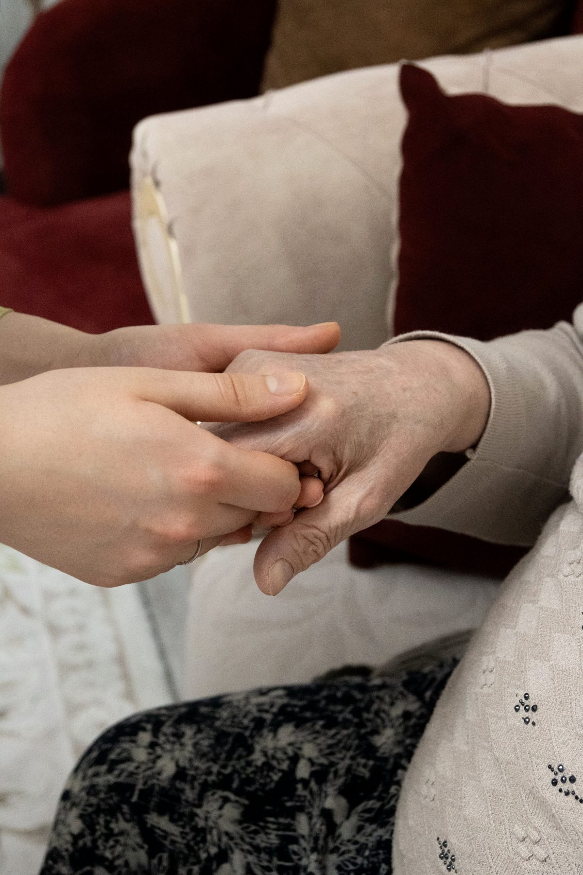 A carer holding an older person's hand